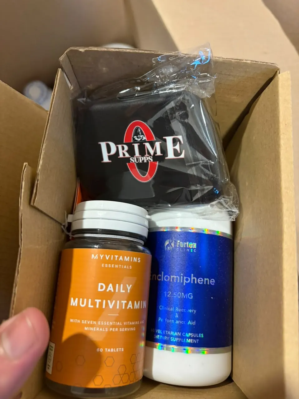 Suplementos y estuche Prime dentro de una caja de cartón
